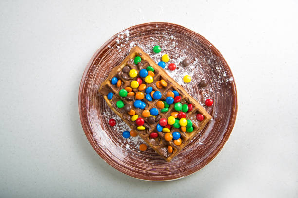 istock Plate of belgian waffles with colored candy 916657178