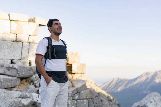 istock Happy young man hiking in countryside 916657428