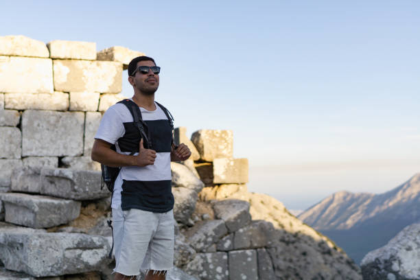 istock Happy young man hiking in countryside 916657562