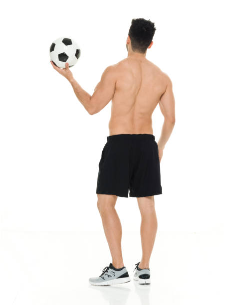 istock Shirtless man holding soccer ball 916661588