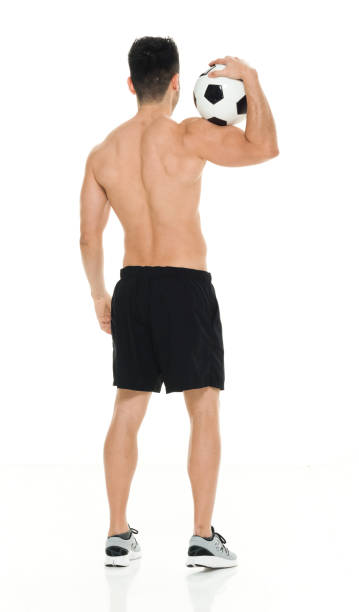 istock Shirtless man holding soccer ball 916661610