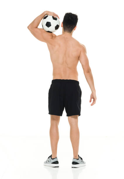 istock Shirtless man holding soccer ball 916661612