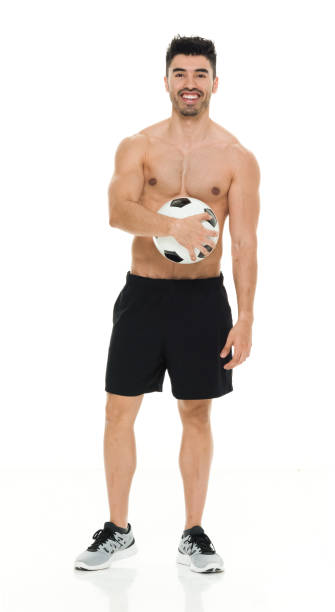 istock Shirtless man holding soccer ball 916661714
