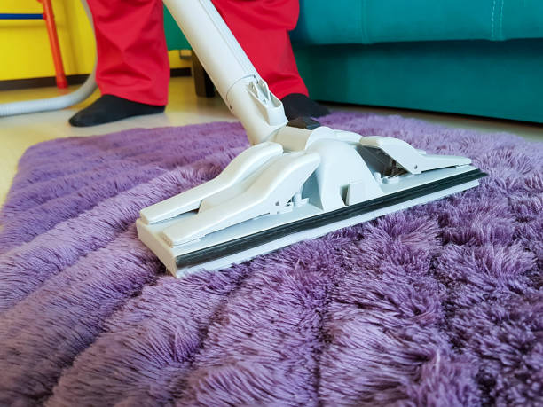 istock man vacuuming the carpet in the room 916661888