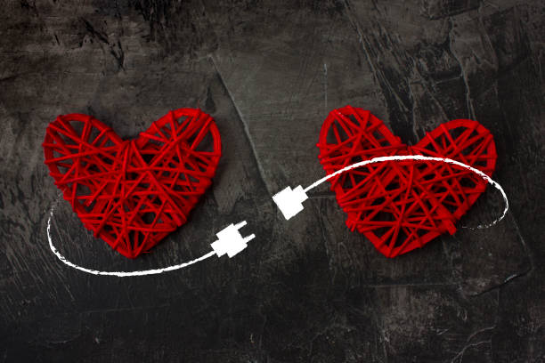 Two hearts connected by USB cable. Theme of love, wedding, Valentine's Day