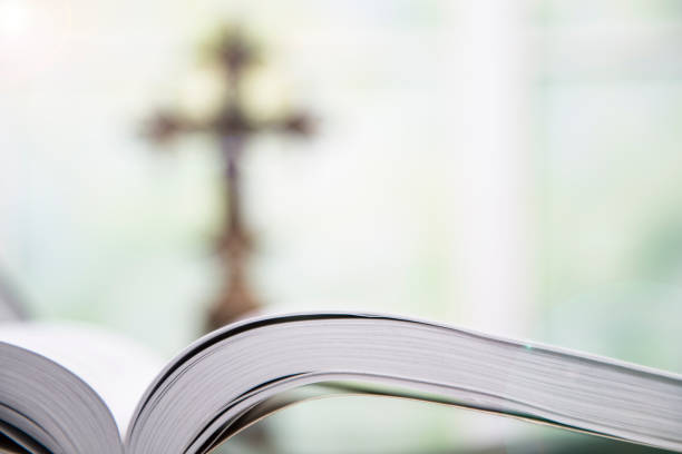 istock Open Bible and Christian cross for Easter. 916664776