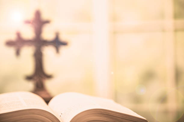istock Open Bible and Christian cross for Easter. 916664996
