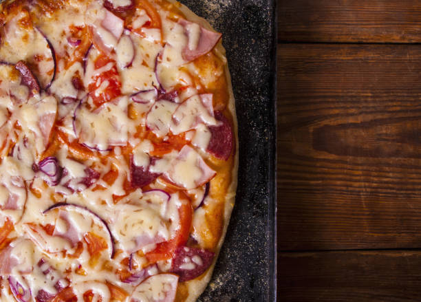 istock Homemade Pizza on a rustic wooden table 916673808