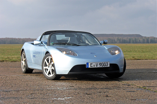 Warsaw, Poland – November 18th, 2009: Zero emission Tesla Roadster (2008-2012) stopped on the road. The Roadster model is the first vehicle from Tesla brand. This model is also the first car in space.