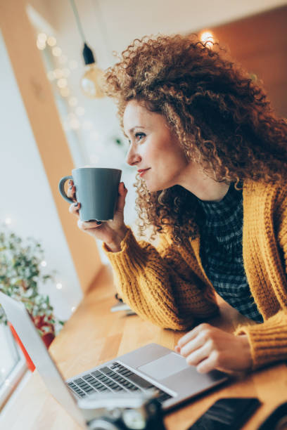 istock Young woman working on a laptop 916683606