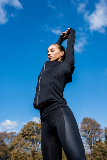 istock woman stretching outdoors 916701256