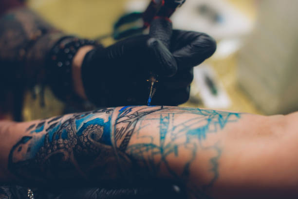 istock Artist finishing a tattoo 916704976