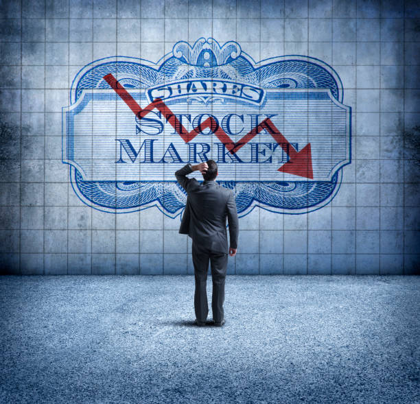 istock Businessman Looking Up At a Chart That Indicates A Falling Stock Market 916713844