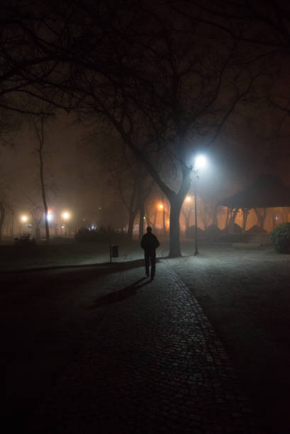 istock Lonely man walking in the night 916725240