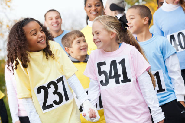 istock Cheerful young girls smile while participating in charity event 916727482