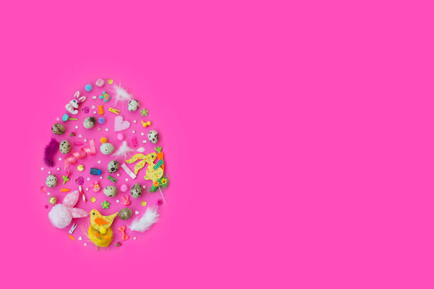 istock Quail eggs and decoration, in egg shape, on pink background with copy space; easter background 916731418