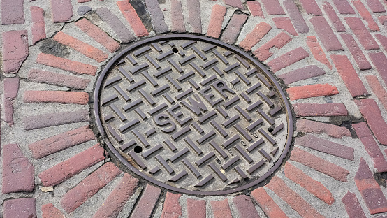 A distressed city sewer manhole cover.
