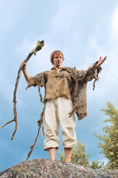 istock guy in a burlap suit and a wooden staff 916743364
