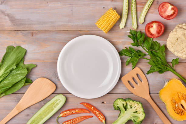 istock Include fresh organic vegetables and white plate on wooden floor with copy space still life 916767246