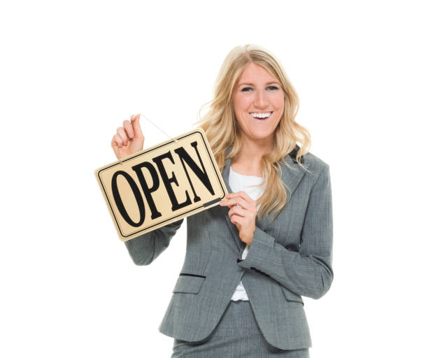 istock Businesswoman holding open sign 916773390