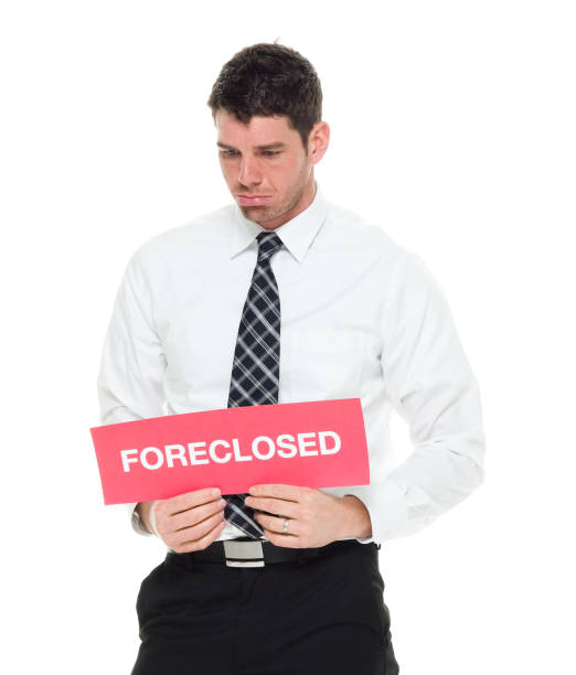 waist up businessman holding foreclosed sign - foreclosed imagens e fotografias de stock