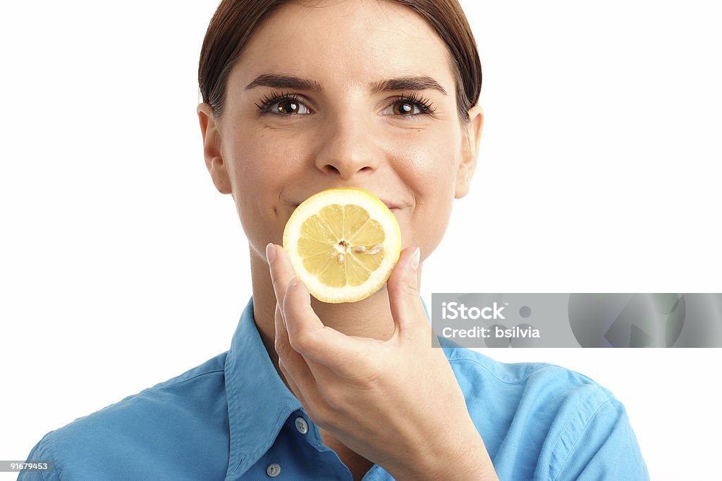 Young woman holding a slice of lemon  20-29 Years Stock Photo