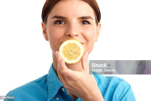 Young Woman Holding A Slice Of Lemon Stock Photo - Download Image Now - 20-29 Years, Adult, Adults Only