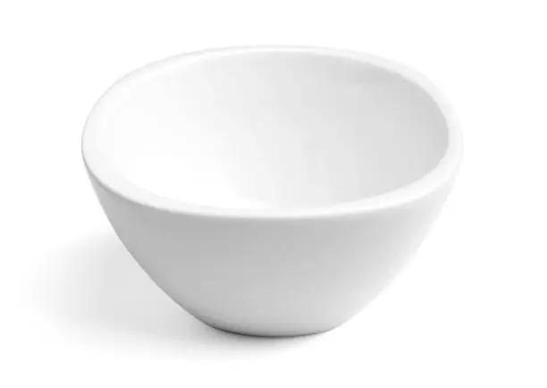 Empty white porcelain dinner bowl on white background with soft natural shadow. Clipping path included