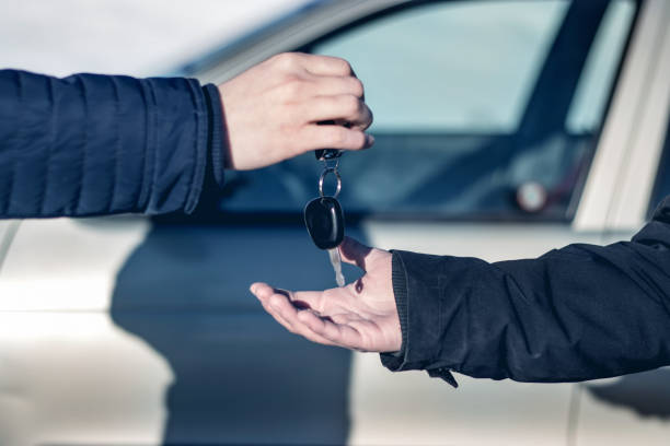 Solemn transfer the key the buyer of a new car stock photo