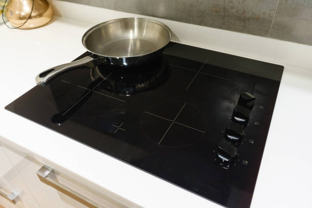 istock Metal Pot and pan on induction hob in modern kitchen. modern kitchen pot cooking induction electrical stove hob concept 916797194