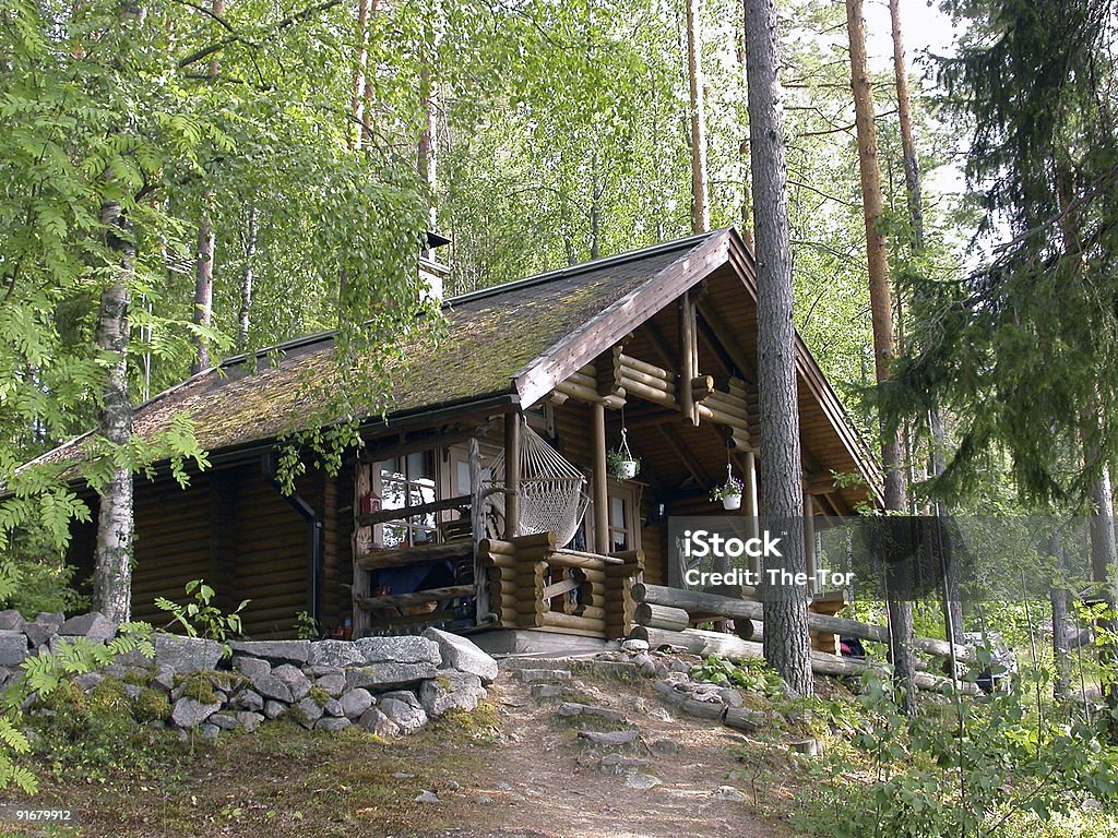 A pretty log cabin in the woods A log cabin in the Finnish forest. Log Cabin Stock Photo