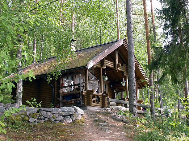A pretty log cabin in the woods stock photo