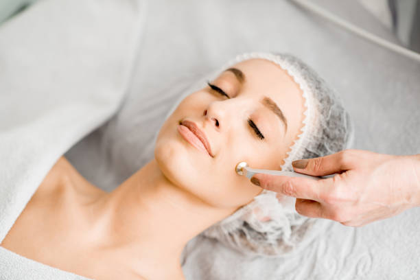 Woman during the facial treatment procedure Young woman during the facial treatment procedure in the cosmetology office microdermabrasion stock pictures, royalty-free photos & images