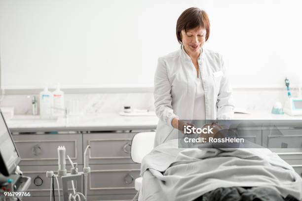 Senior Woman Cosmetologist During The Procedure Stock Photo - Download Image Now - Dermatology, Peel - Plant Part, Adult