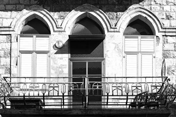 Windows of traditional stoned house in old Acre. Arab architecture of the old city of Akko in Israel. Black and white picture