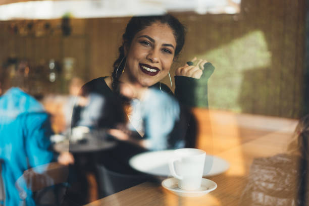 istock Young women drinking coffee at a cafe 916808062