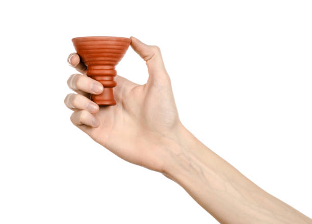 istock Hookah topic: Bartender holding a clay bowl for tobacco on a white background isolated 916808338