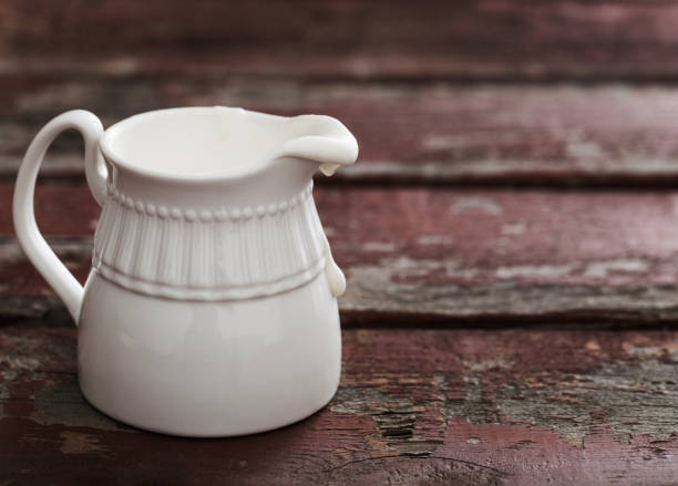 istock milk cream in a jug on old wooden table 916808540