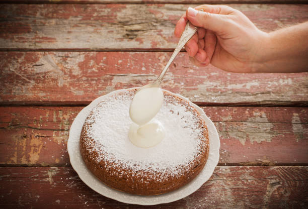 istock overlaying cream on a sponge cake 916808578