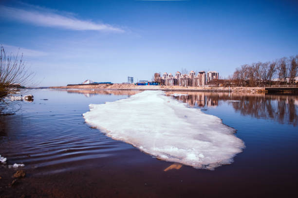 Drifting ice on the river. Winter in the city. Spring landscape. Seasons. Arrival of spring.in the spring the frozen river melts ice