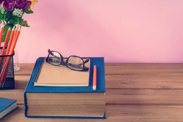 istock book and pencil note on wood table 916815036
