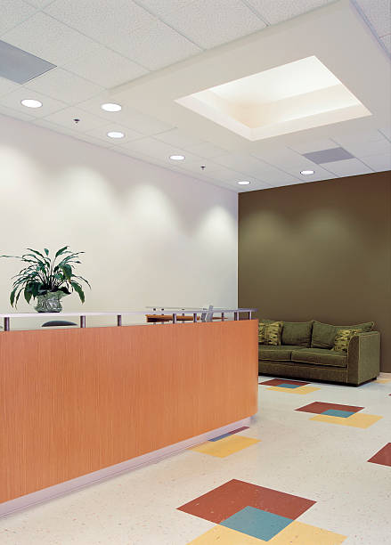 istock Reception area with wooden desk, sofa and spotlights 91681780