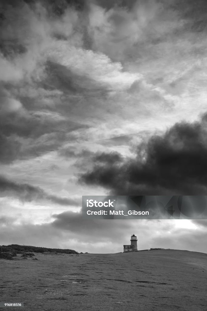 Stunning black and white landscape image of Belle Tout lighthouse on South Downs National Park during stormy sky Beautiful black and white landscape image of Belle Tout lighthouse on South Downs National Park during stormy sky Beach Stock Photo