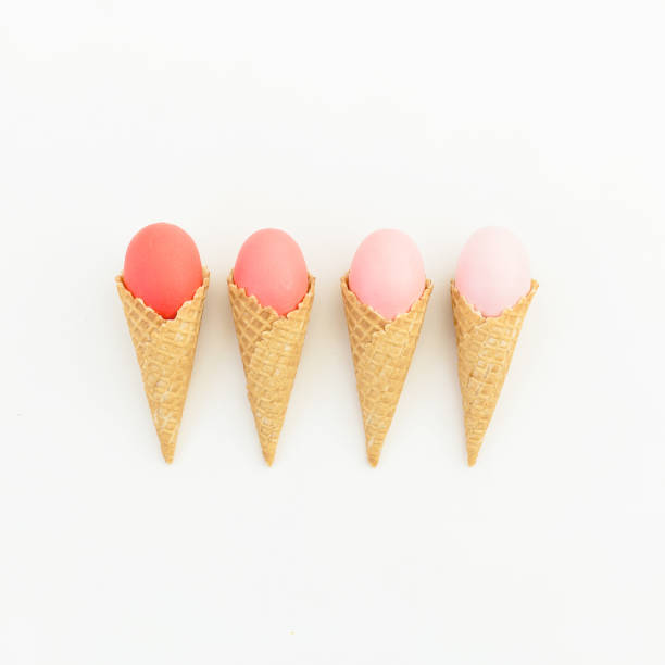 istock Pink Easter eggs in waffle cones isolated on white background. Flat lay. Top view. Creative Easter concept. 916830054