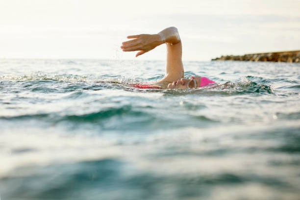 istock Determined senior swimmer swimming in sea 916835946
