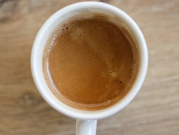 istock Cup of black coffee on wooden background 916836136