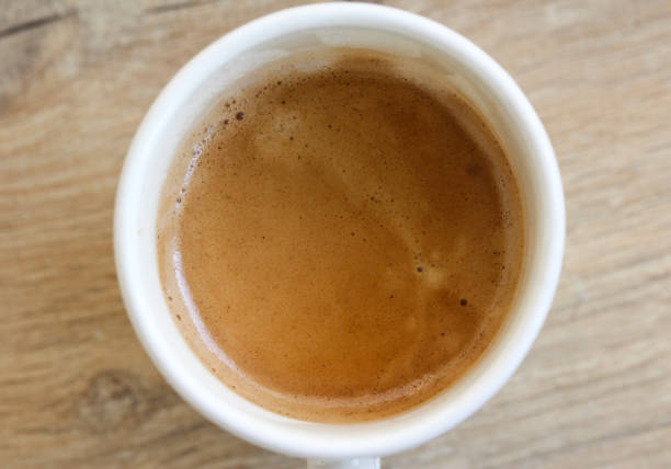 istock Cup of black coffee on wooden background 916836138