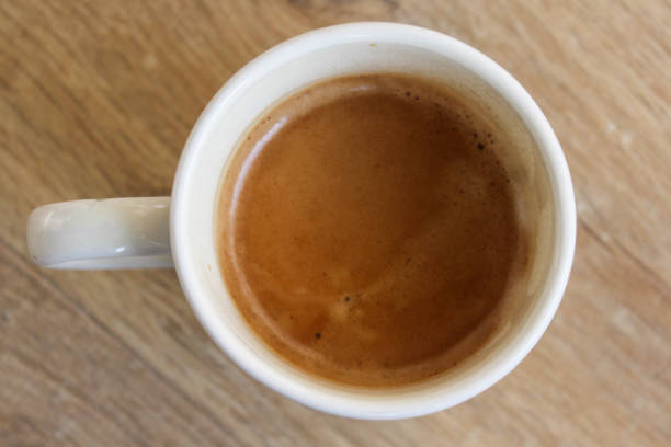 istock Cup of black coffee on wooden background 916836172