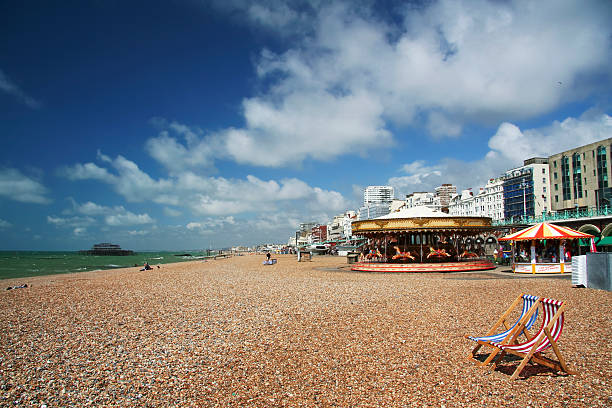 pebble beach with striped red and blue canvas deckchairs, brighton, england