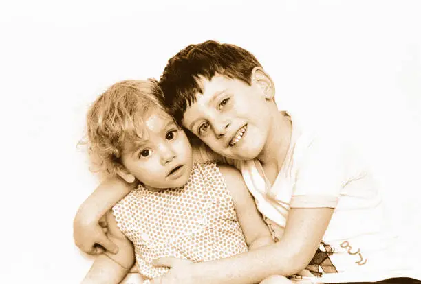 vintage black and white image of a cute brother and sister cut out on white background